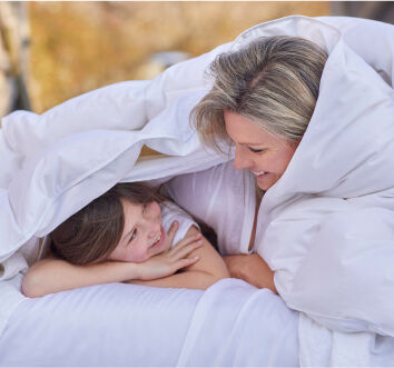 Woman and Child Wrapped in Earth-Friendly Comforter